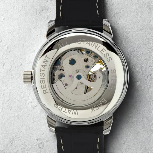 Watch with black strap and visible mechanical components on a light gray background