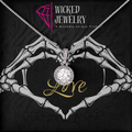 Necklace with skeleton hands holding a 'Love' pendant on Wicked Jewelry packaging.