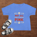 Blue t-shirt with 'Not All Girls Wear Pink' text and black sneakers on a wooden surface