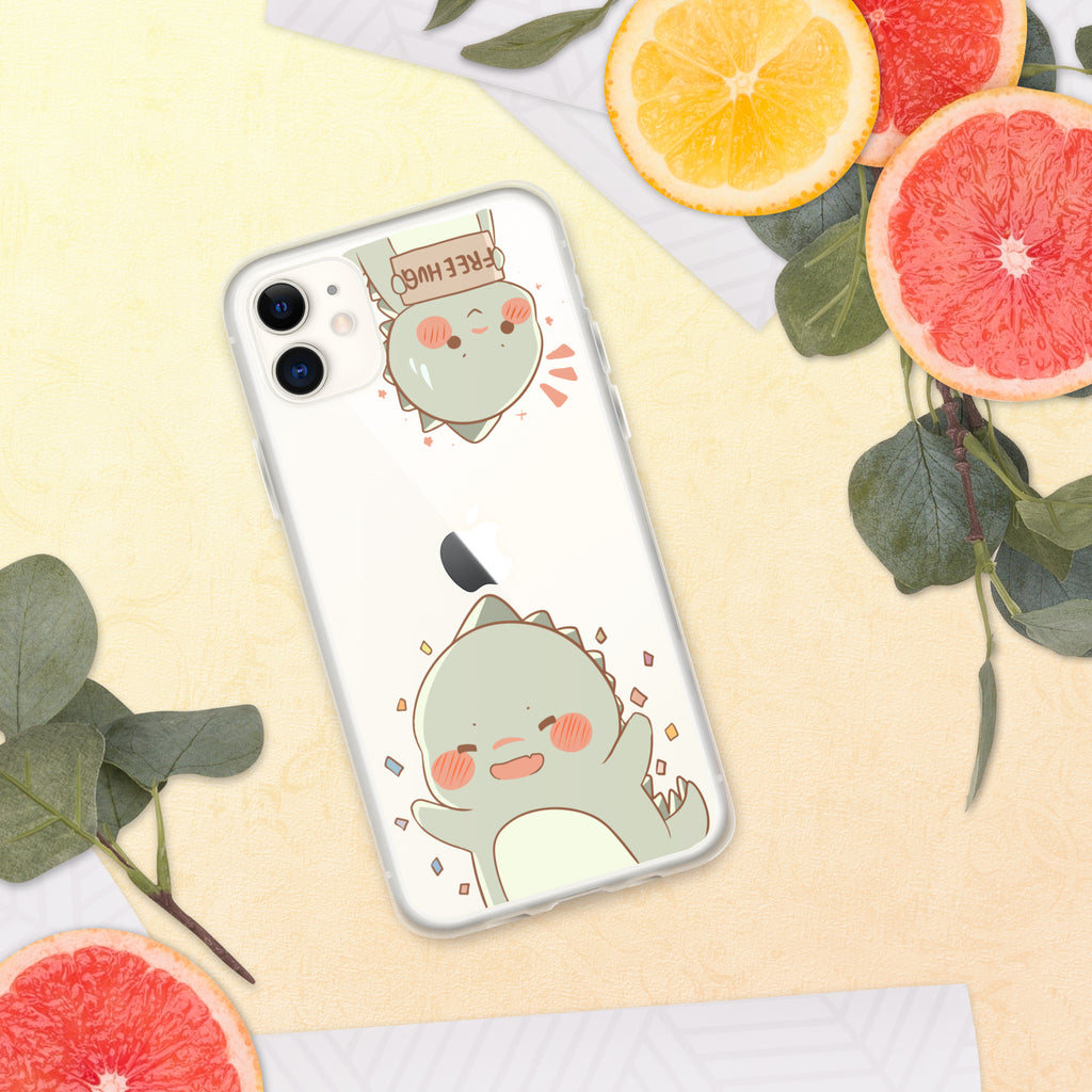 Phone case with a cute green dinosaur design on a yellow surface with fruit and leaves.