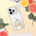 Phone case with a cute dinosaur design on a yellow surface with fruits and leaves.