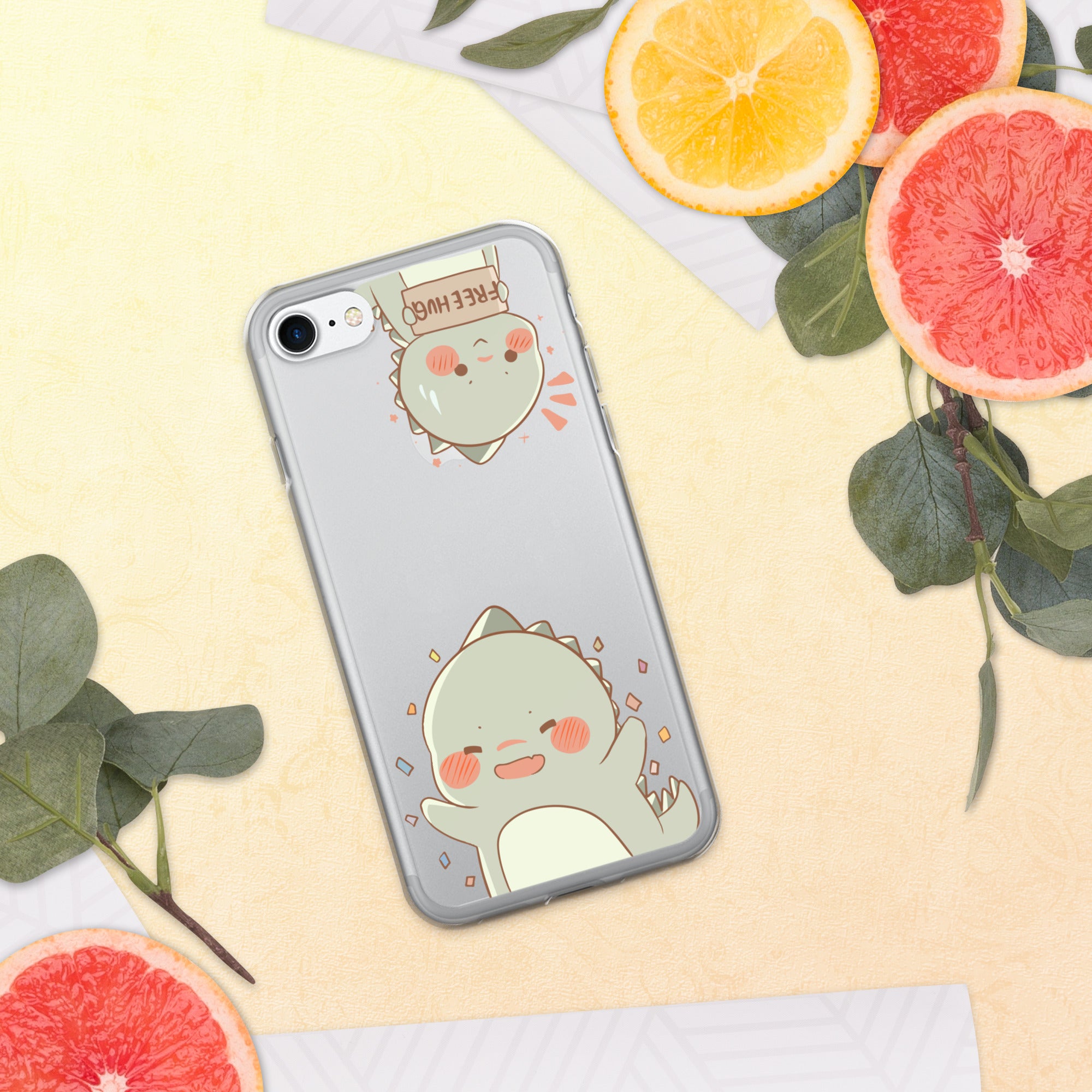 Phone case with a cute dinosaur design on a yellow background with sliced oranges and leaves.