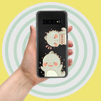 Phone case with cartoon designs held by a hand against a yellow background