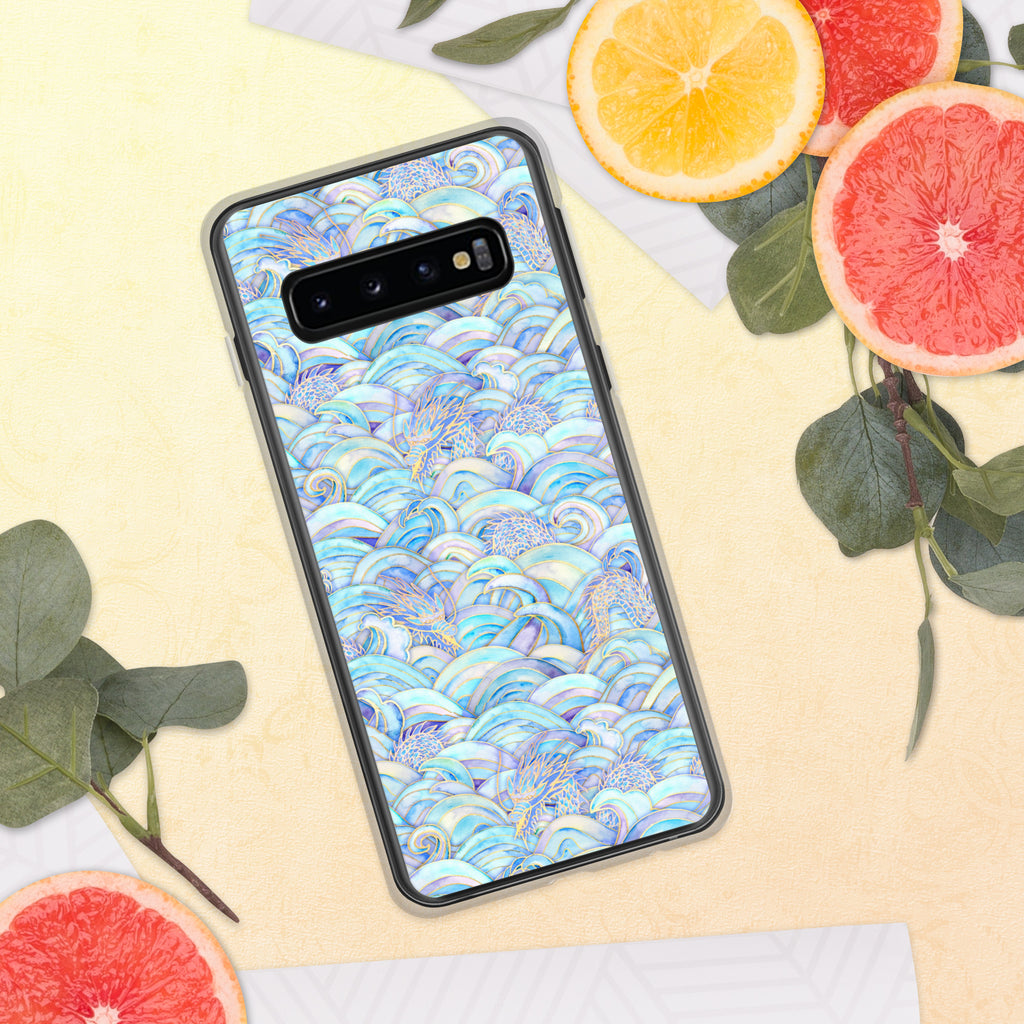 Phone case with a colorful wave pattern on a yellow surface with fruit and leaves.