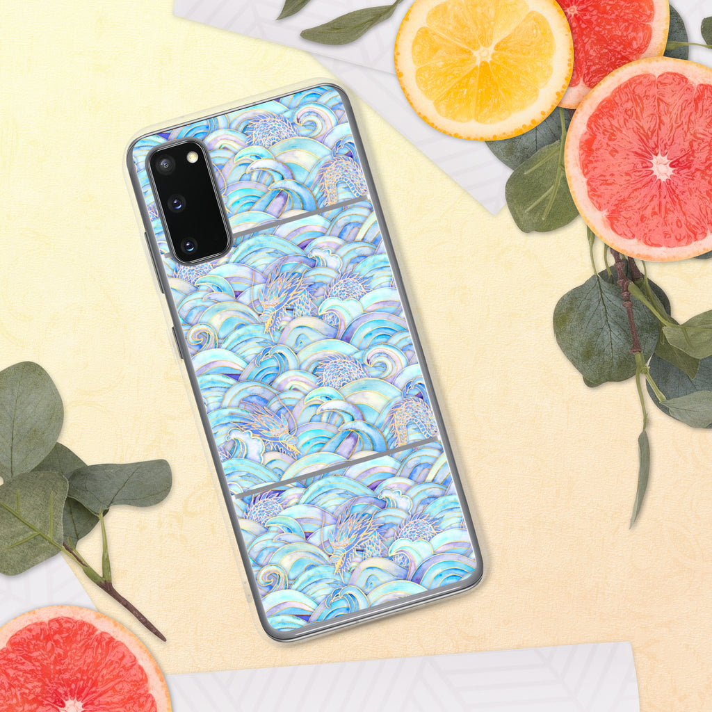 Phone case with a colorful wave pattern on a yellow surface with fruit and leaves.