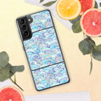 Phone case with a colorful wave pattern on a yellow surface with fruit and leaves.
