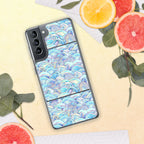 Phone case with a colorful wave pattern on a yellow surface with fruit and leaves.