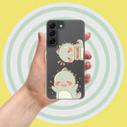 Phone case with cartoon design held by a hand against a yellow background