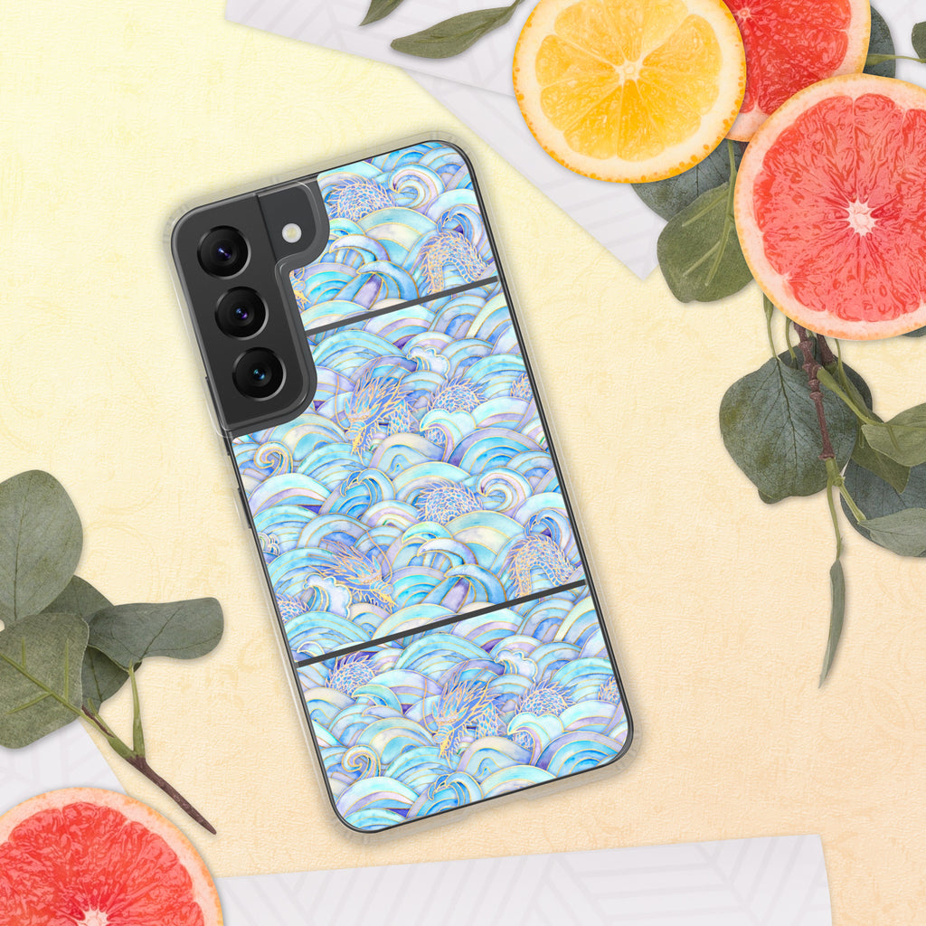 Phone case with a colorful wave pattern on a yellow surface with fruit and leaves.