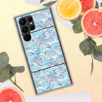 Phone case with wave pattern on a yellow surface with fruit and leaves
