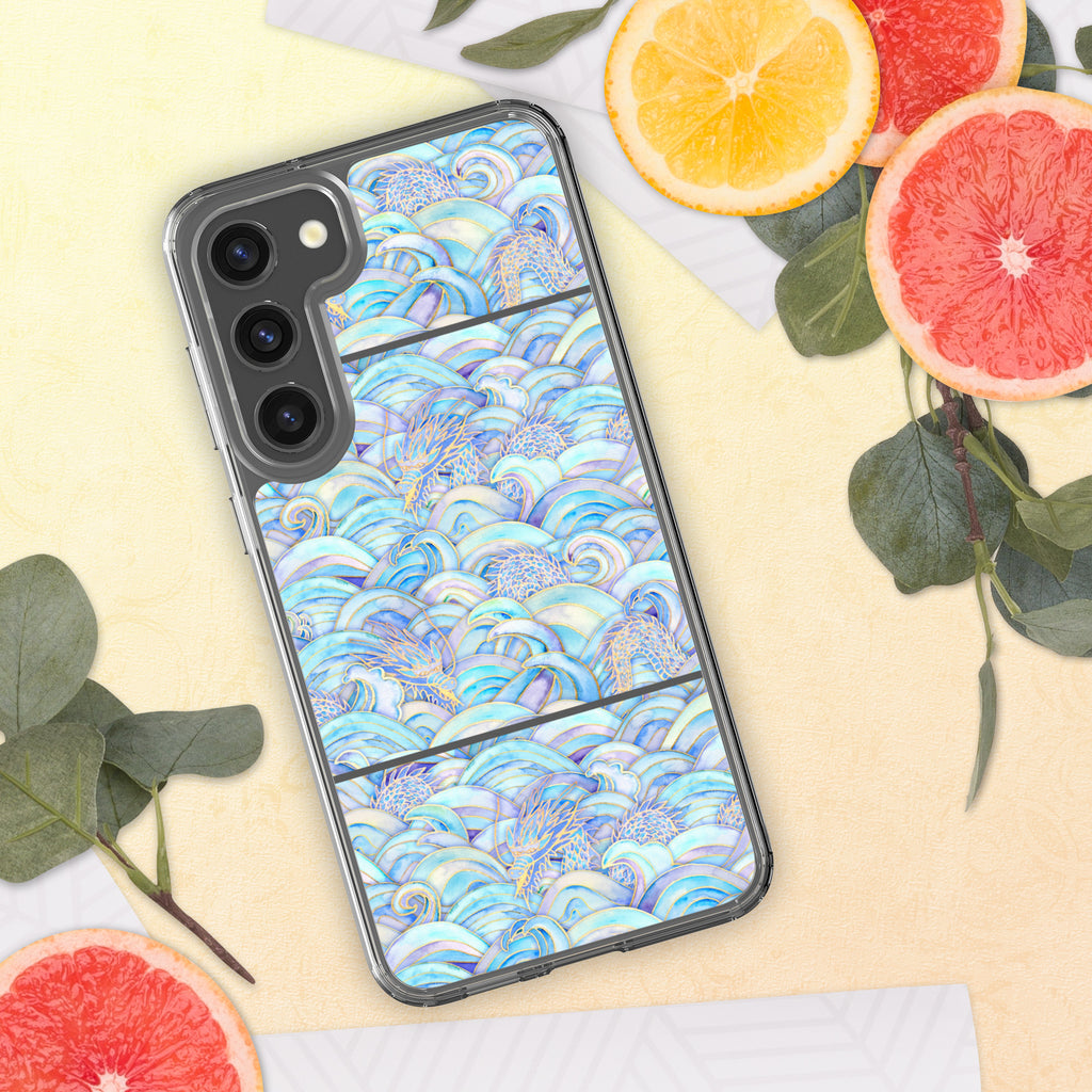 Phone case with a colorful wave pattern on a yellow surface with fruit and leaves.