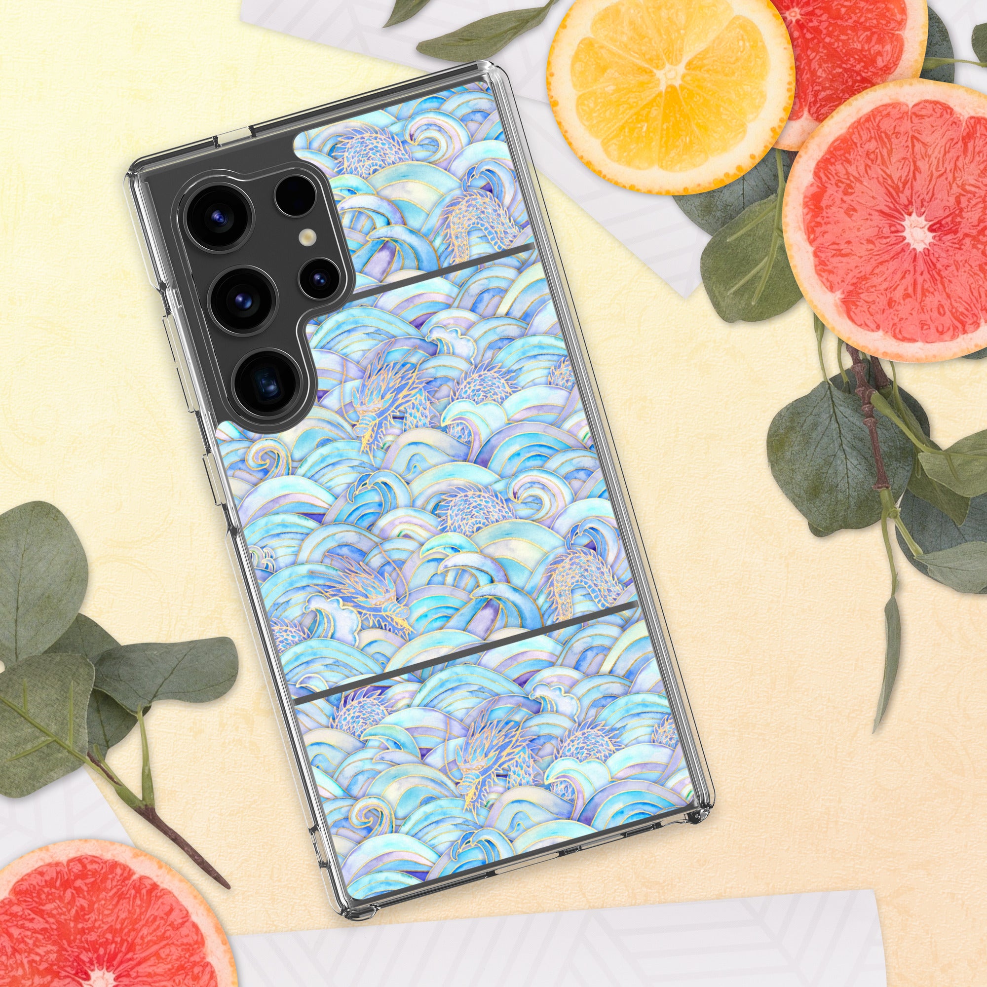 Phone case with colorful wave pattern on a yellow surface with fruit and leaves