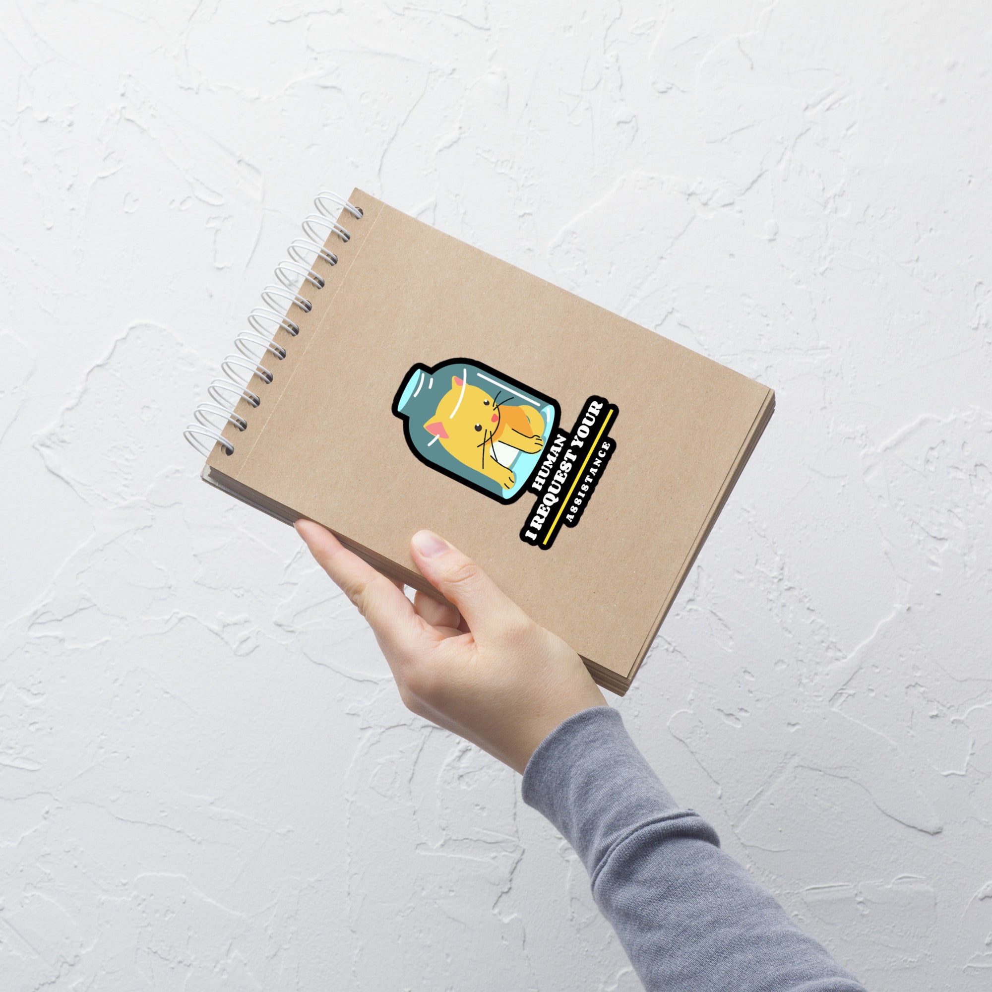 Notebook with a sticker on a white textured surface