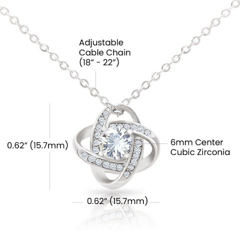 Silver necklace with adjustable cable chain and cubic zirconia pendant on a white background