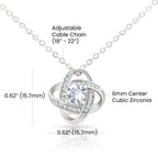Silver necklace with adjustable cable chain and cubic zirconia pendant on a white background