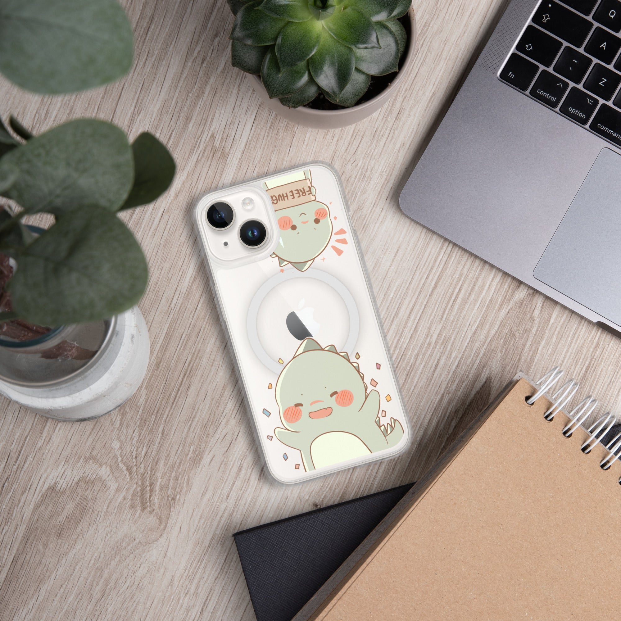 Phone case with cartoon design on a wooden surface with laptop and plants