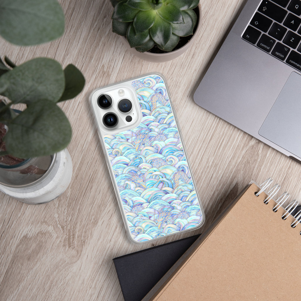 Phone case with a colorful pattern on a wooden surface with a plant and laptop.
