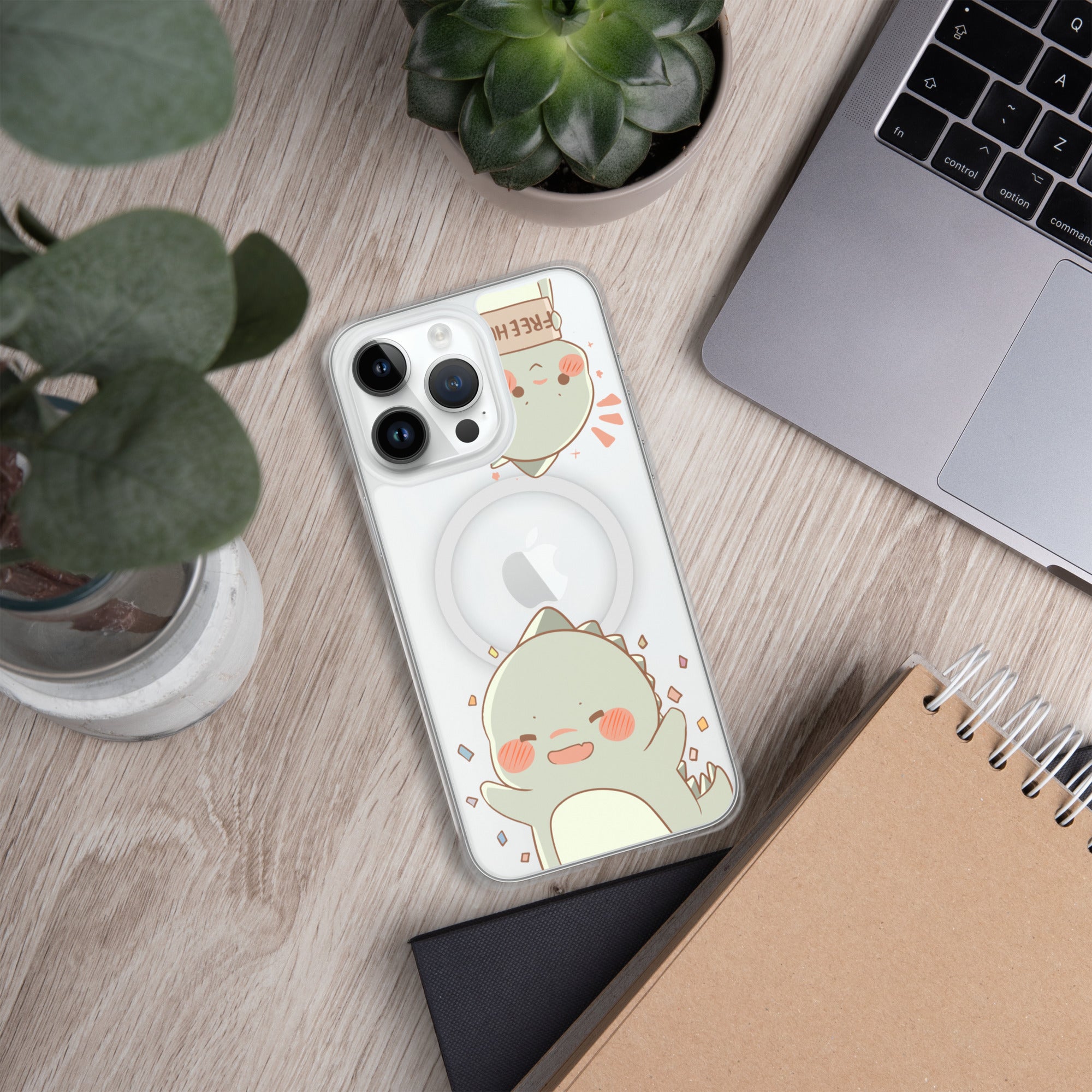 Phone case with cartoon design on a wooden surface with laptop and plants