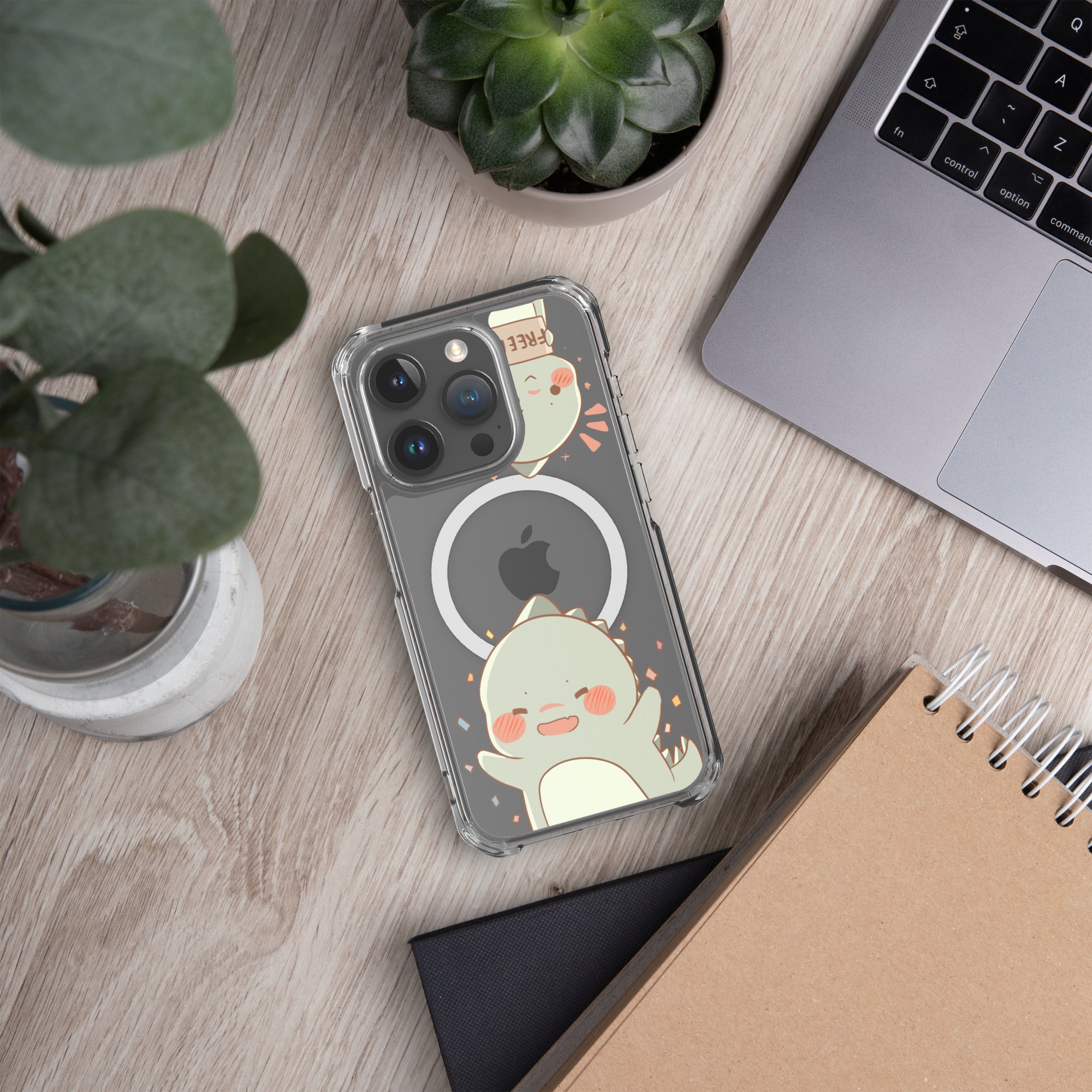 Phone case with cartoon design on a desk with laptop and plants
