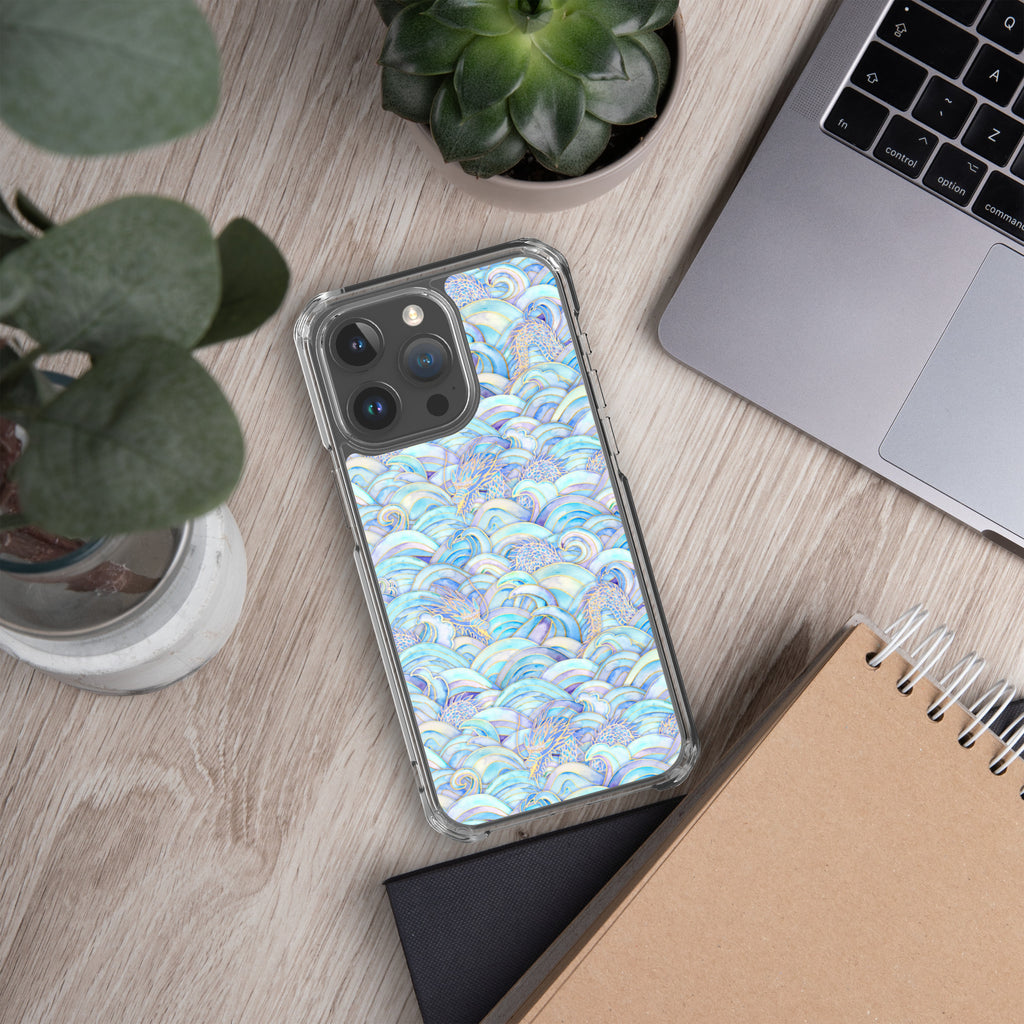 Phone case with blue and white pattern on a wooden desk with laptop and notebook