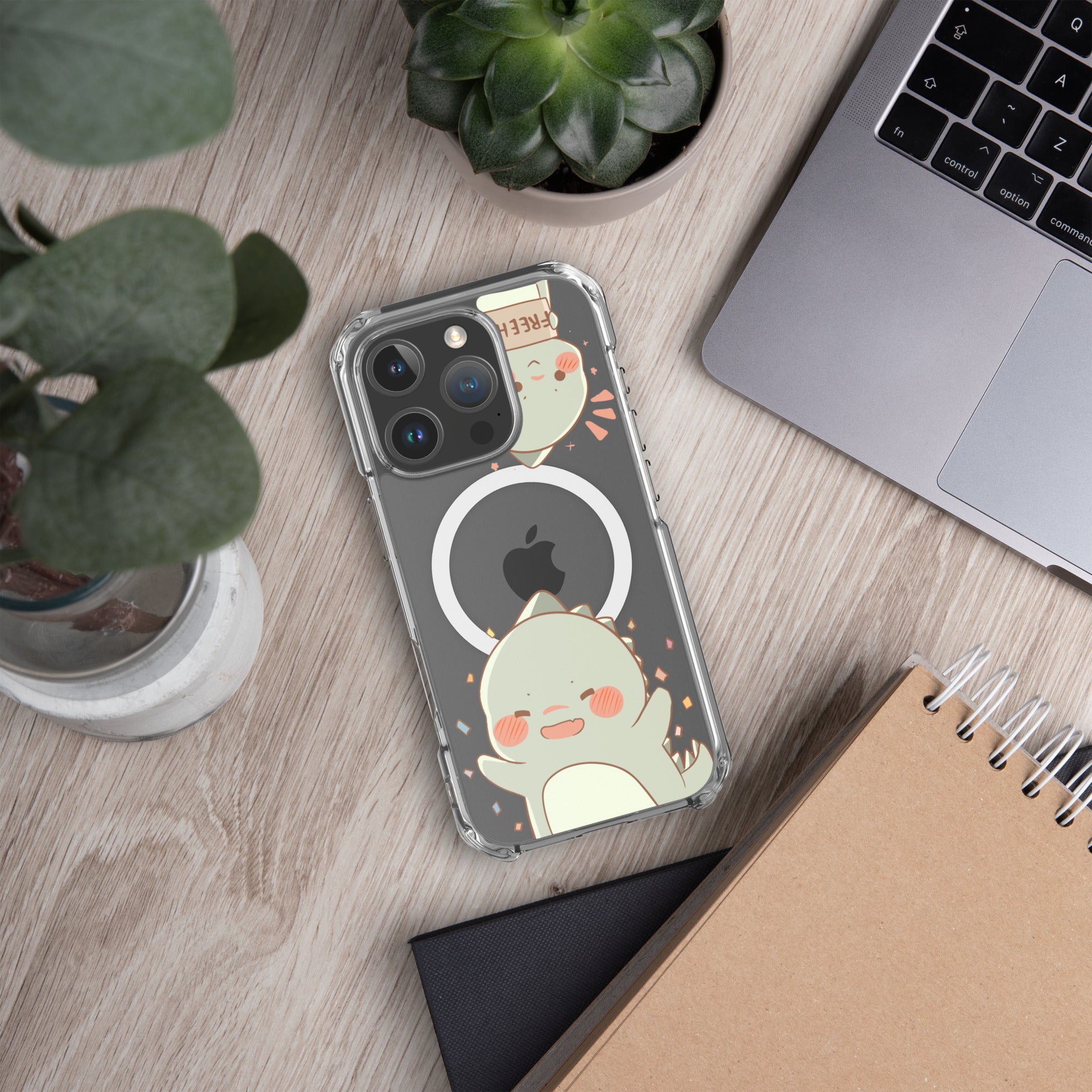 Phone case with a cute design on a desk with a laptop and notebook