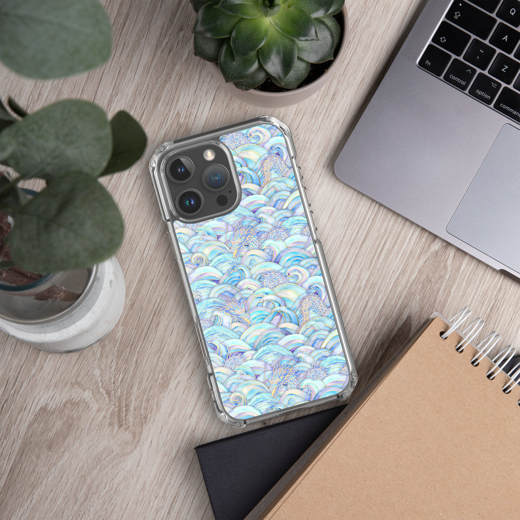 Phone case with a colorful pattern on a wooden surface with a laptop and plant.