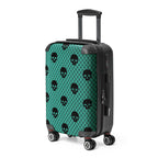 Suitcase with black skull pattern on a teal background