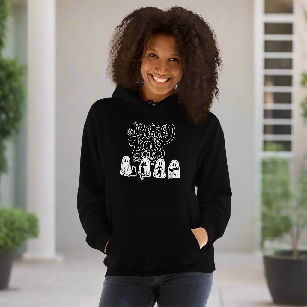Person wearing a black hoodie with text and graphics on a white background