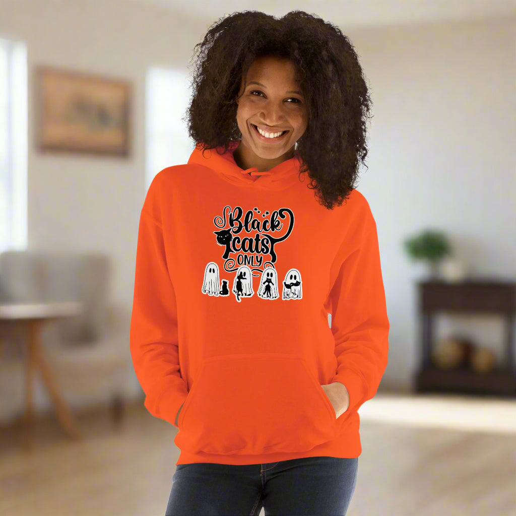Person wearing an orange hoodie with Halloween-themed design on a white background